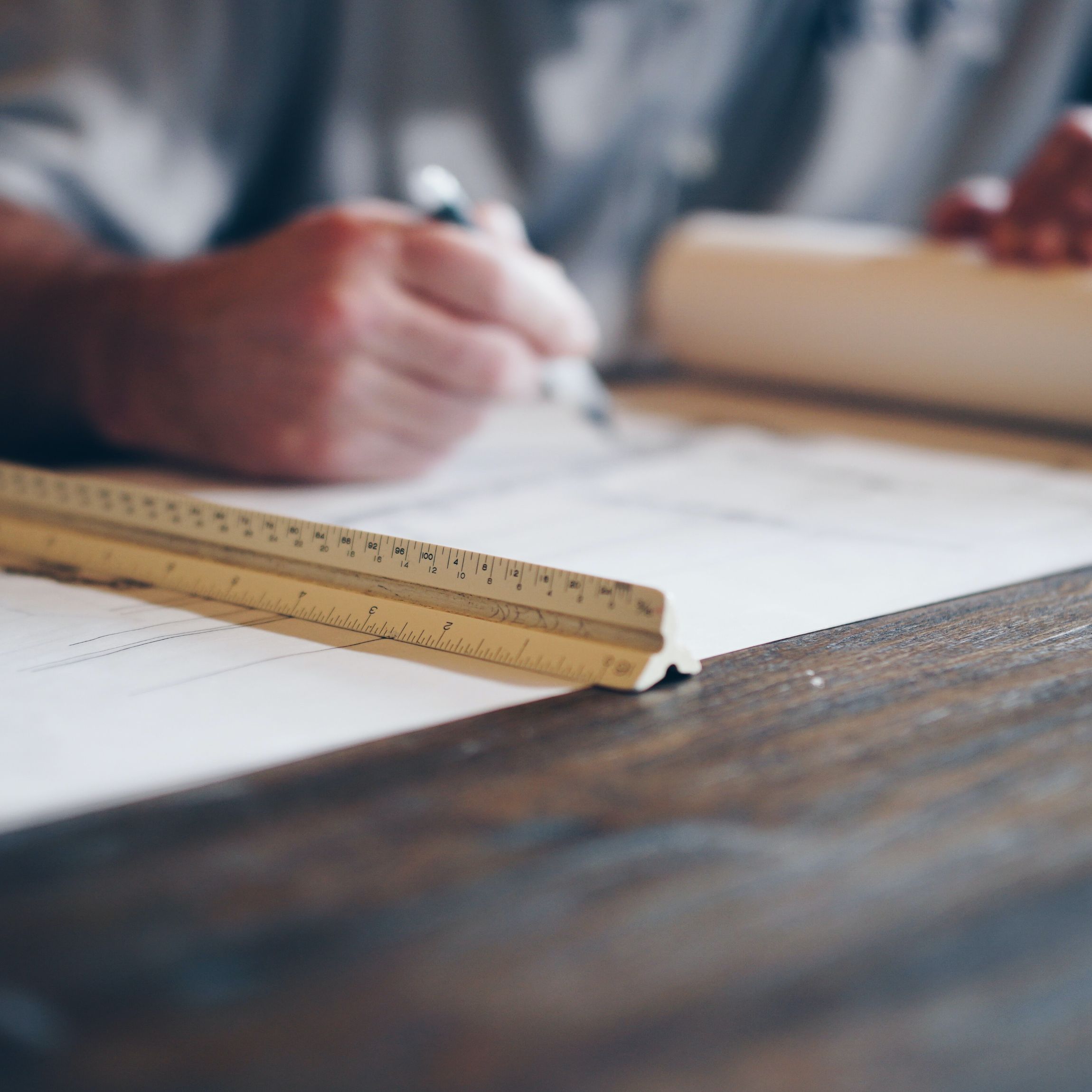 man writing on plans